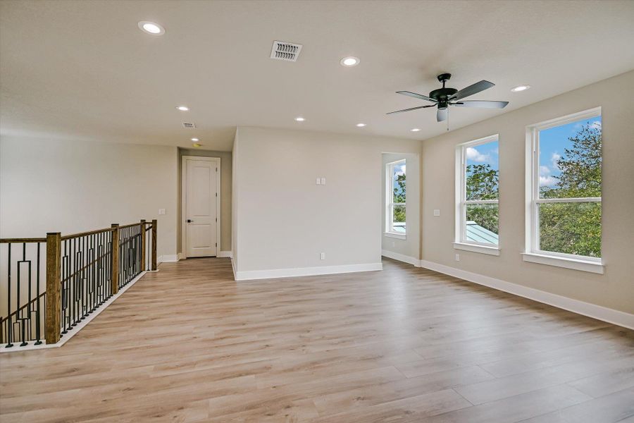 Empty room with light wood-style floors, recessed lighting, and a ceiling fan