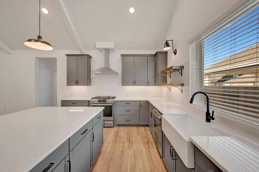 Stylish kitchen with grey cabinets and floating shelves Stylish kitchen with grey cabinets and floating shelves