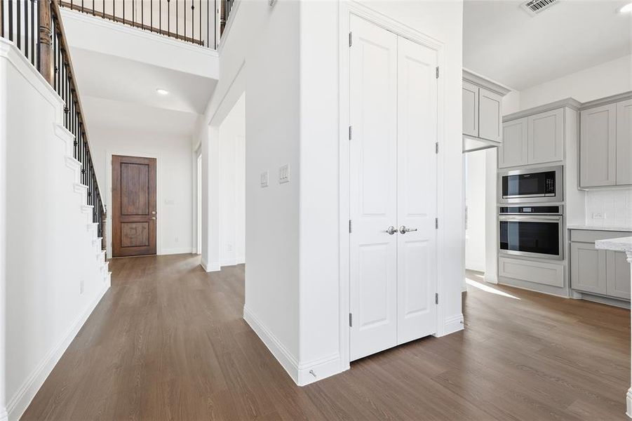 Hallway with recessed lighting, dark wood finished floors, and stairway Hallway with recessed lighting, dark wood finished floors, and stairway