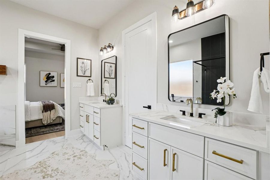 Ensuite bathroom with two vanities, a stall shower, and light marble finish floors
