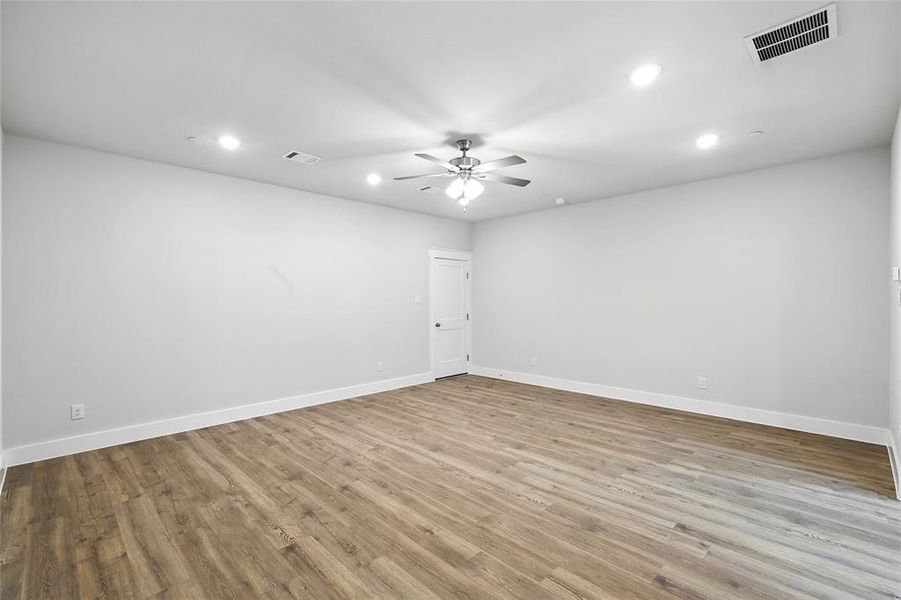 Empty room featuring recessed lighting, light wood-type flooring, and a ceiling fan