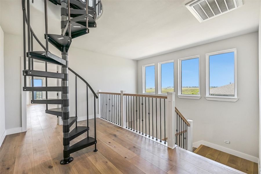 The dramatic spiral staircase leads to the observatory cupola above, creating a stunning architectural focal point. Every step builds anticipation for the breathtaking 360 degree panoramic views waiting at the top.