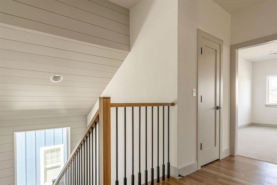 Hallway with wood finished floors and baseboards