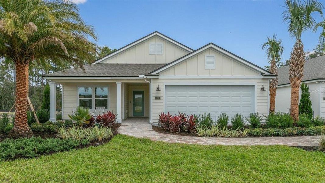 Front exterior of a new home in American Village, Palm Coast, FL, highlighting curb appeal (Image 22).