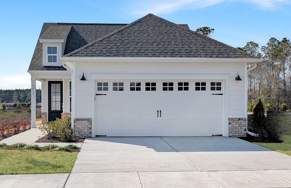 Front exterior of a new home in Del Webb Wilmington at Mallory Creek, Leland, NC, highlighting curb appeal (Image 20).