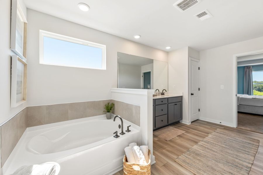 A bathroom with a tub and sink.