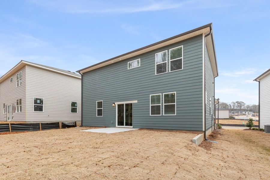 A blue house with a white door with Mark Twain Boyhood Home & Museum in the background. A blue house with a white door with Mark Twain Boyhood Home & Museum in the background.