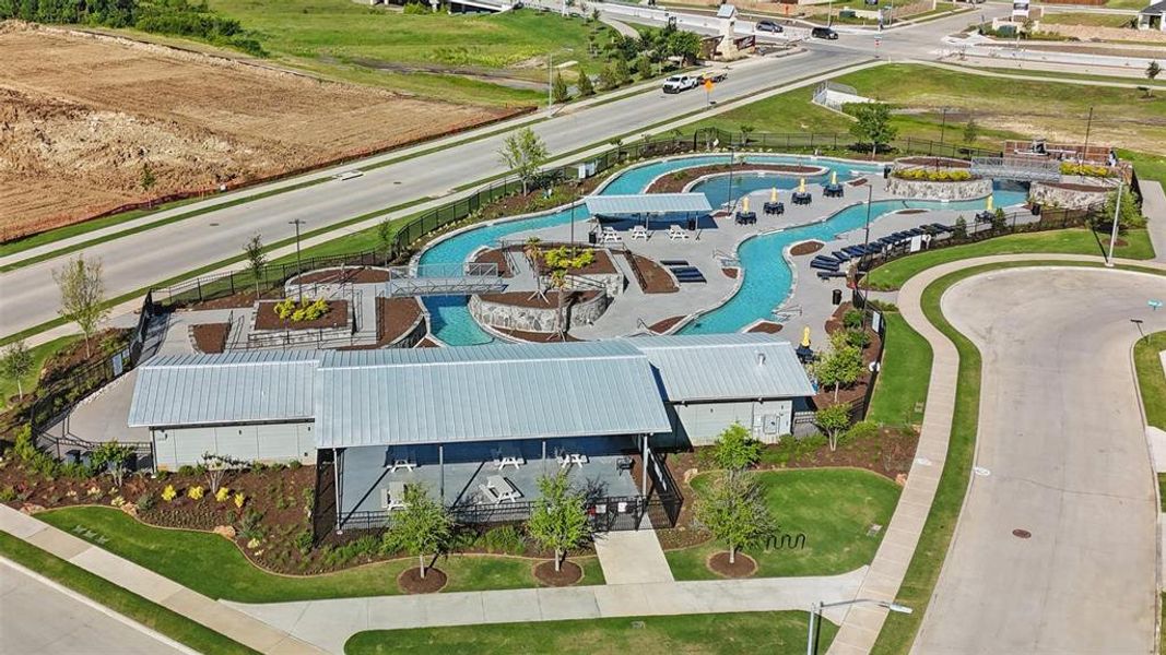 Community amenity center featuring a lazy river pool, multiple bridges, a covered patio area, and structured landscaping