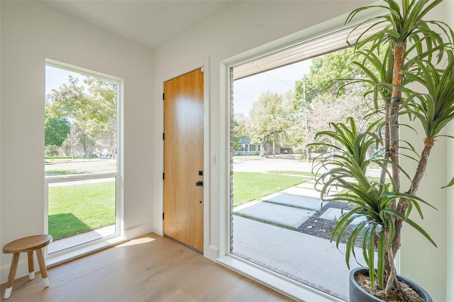 Doorway with light hardwood / wood-style flooring and plenty of natural light