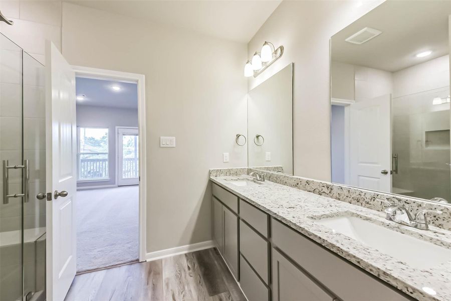 The primary bathroom features modern finishes, a spacious shower, and quartz countertops with dual sinks. The primary bathroom features modern finishes, a spacious shower, and quartz countertops with dual sinks.