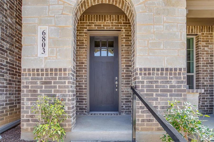 Doorway to property featuring brick siding Doorway to property featuring brick siding