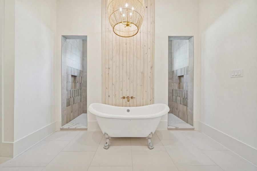 Clawfoot tub with a wall of shoji washed wood and an oversized accent light above. The shower is behind the wall.