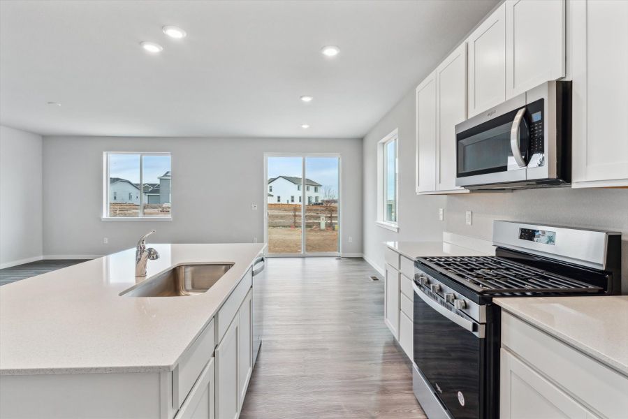 A kitchen with white cabinets.