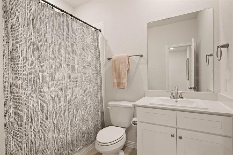 Bathroom featuring vanity and toilet