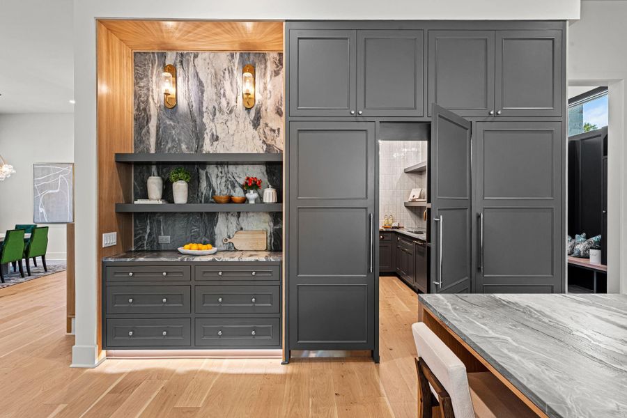 Pantry entrance blends in at refrigeration wall for a seamless look Pantry entrance blends in at refrigeration wall for a seamless look