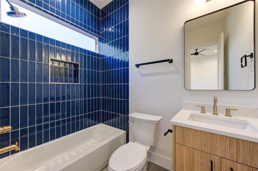 Guest Bathroom 2. Bedroom 2 enjoys its own private bathroom. All bathrooms feature American Standard toilets, Delta champagne bronze fixtures, 3cm quartz, contemporary cabinetry, and designer tile selections.