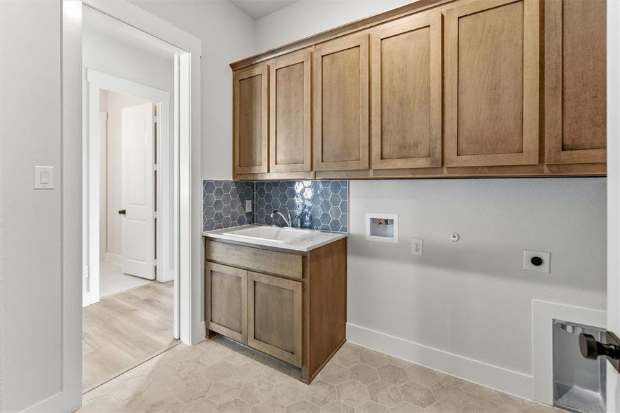 Laundry room featuring hookup for a washing machine, hookup for an electric dryer, and cabinet space