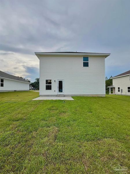 Front exterior of a new home in Pine Top, Cantonment, FL, highlighting curb appeal (Image 2).