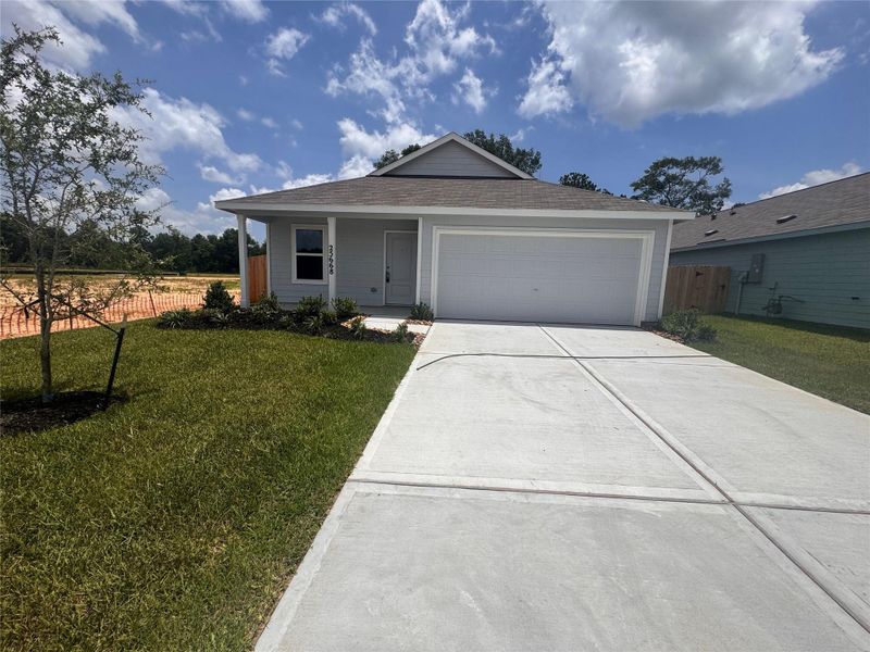 Front exterior of a new home in Pinewood Trails, Cleveland, TX, highlighting curb appeal (Image 2).