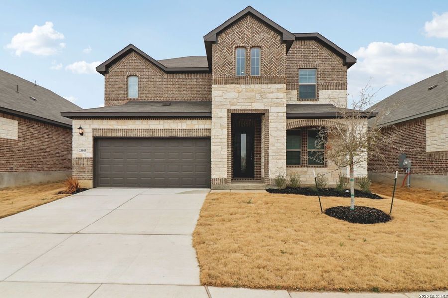 Front exterior of a new home in Fox Falls, Boerne, TX, highlighting curb appeal (Image 2). Front exterior of a new home in Fox Falls, Boerne, TX, highlighting curb appeal (Image 2).