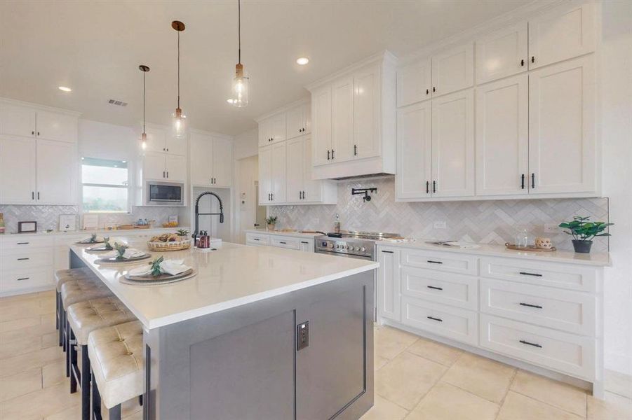 Kitchen with white cabinetry, light countertops, a sink, and stainless steel appliances Kitchen with white cabinetry, light countertops, a sink, and stainless steel appliances