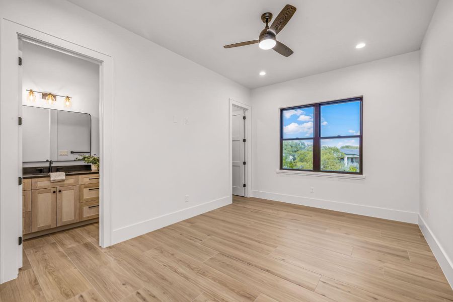 Unfurnished room featuring ceiling fan, light wood finished floors, recessed lighting, and baseboards