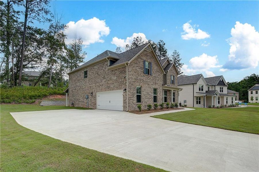 Front exterior of a new home in Trinity Park, McDonough, GA, highlighting curb appeal (Image 15).