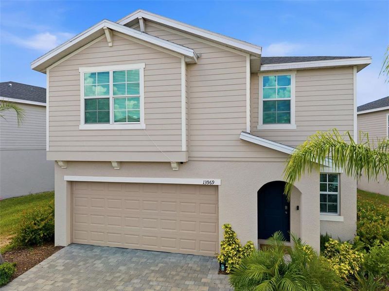 Front exterior of a new home in Aurora at Lakewood Ranch, Bradenton, FL, highlighting curb appeal (Image 27). Front exterior of a new home in Aurora at Lakewood Ranch, Bradenton, FL, highlighting curb appeal (Image 27).