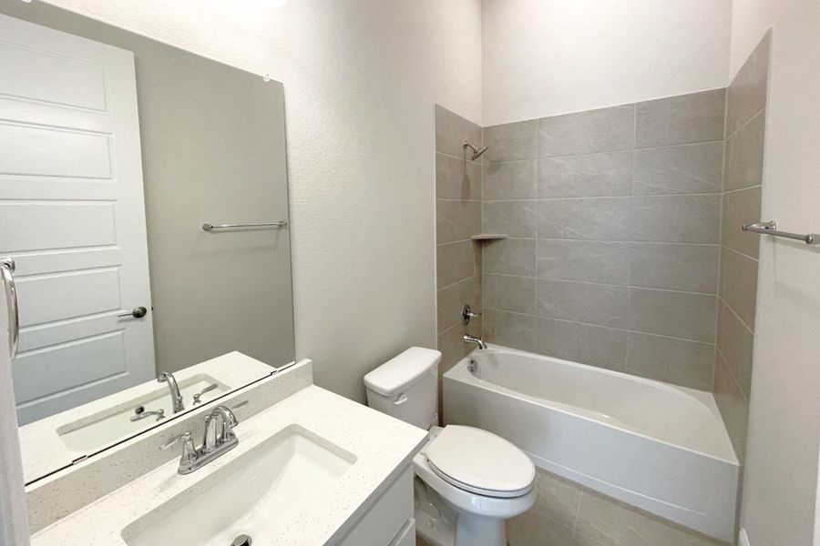 A well-appointed bathroom offers clean lines and a contemporary vanity.