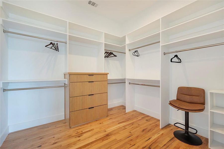 Spacious closet featuring light hardwood / wood-style floors