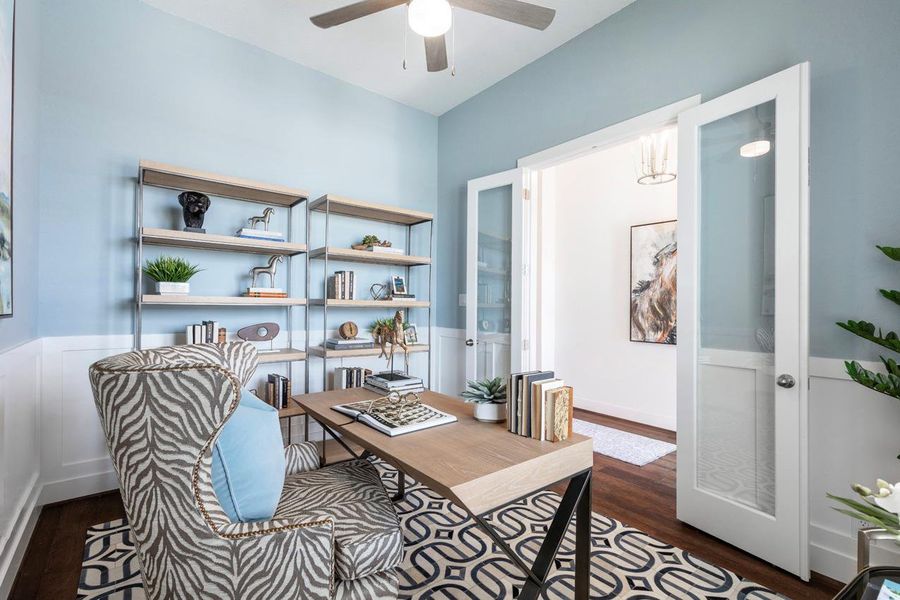 Home office with a wainscoted wall, ceiling fan, and wood finished floors Home office with a wainscoted wall, ceiling fan, and wood finished floors