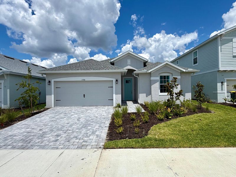 Representative exterior photo of a completed home built from the Juno by William Ryan Homes in The Sanctuary – Resort Collection, Punta Gorda, FL (Image 22).