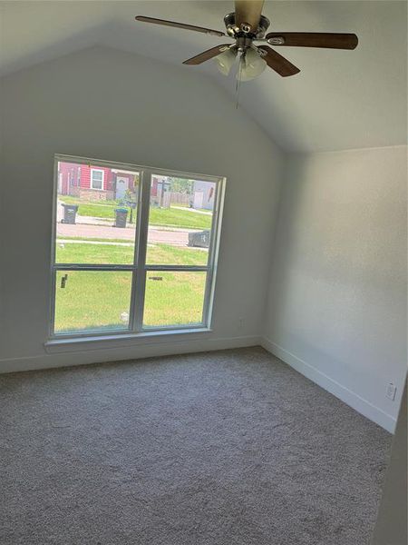 2nd Bedroom with carpet, ceiling fan, and lofted ceiling