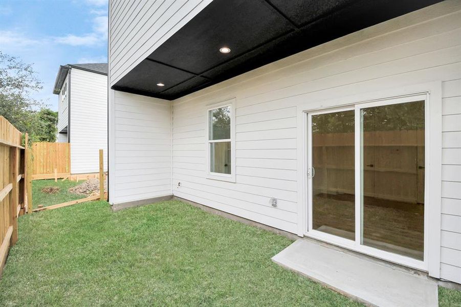 This cozy side yard offers a private outdoor space with a well-maintained lawn and a high wooden fence for added privacy. Situated adjacent to a room with direct access, it’s ideal for enjoying fresh air right outside the home.