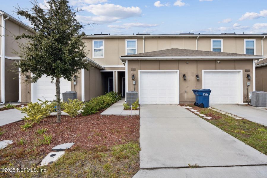 Front exterior of a new home in , Yulee, FL, highlighting curb appeal (Image 1).