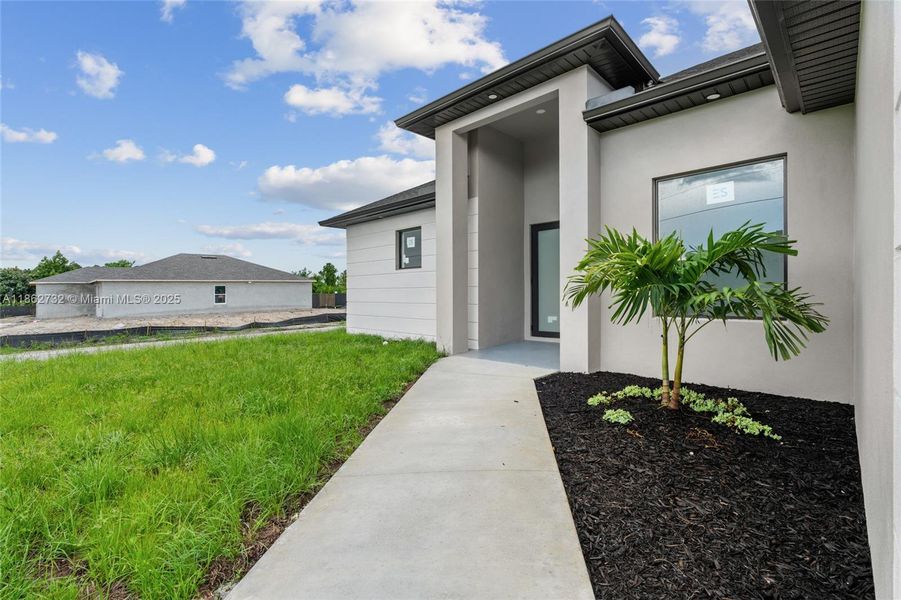 Front exterior of a new home in , Lehigh Acres, FL, highlighting curb appeal (Image 19). Front exterior of a new home in , Lehigh Acres, FL, highlighting curb appeal (Image 19).