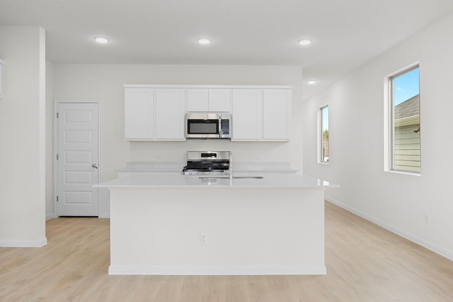 Kitchen in the Magnolia home plan by Trophy Signature Homes – REPRESENTATIVE PHOTO
