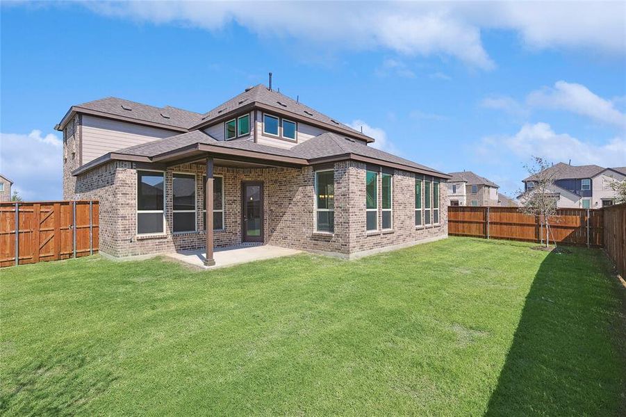 Back of house featuring a patio area and a lawn