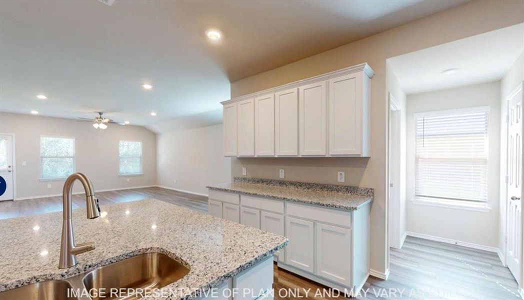 Kitchen island with a stainless steel undermount sink and a gooseneck faucet Kitchen island with a stainless steel undermount sink and a gooseneck faucet