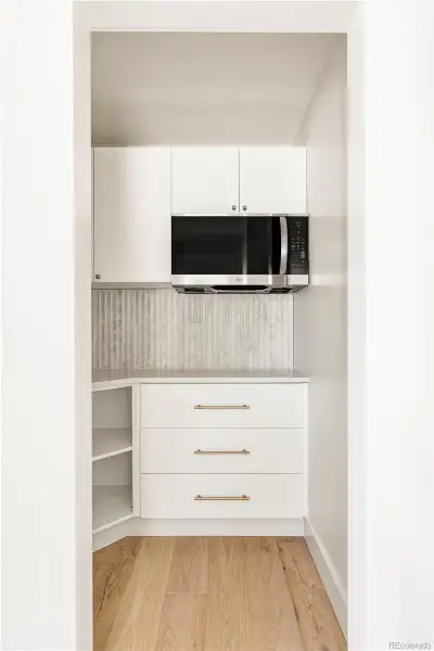 Walk-in pantry with additional storage and prep space