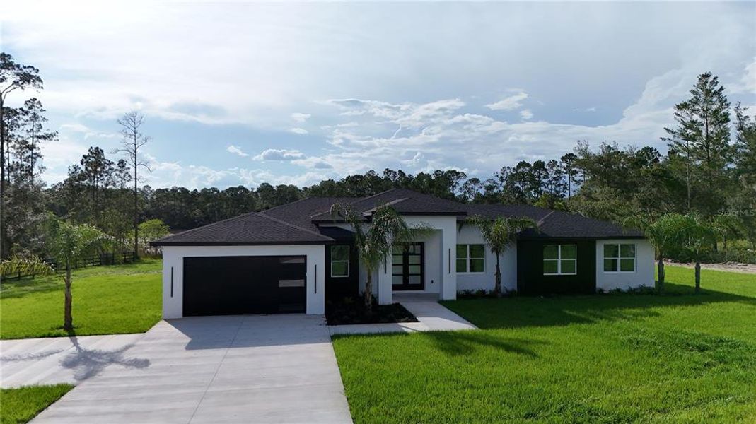 Front exterior of a new home in , Eustis, FL, highlighting curb appeal (Image 2).