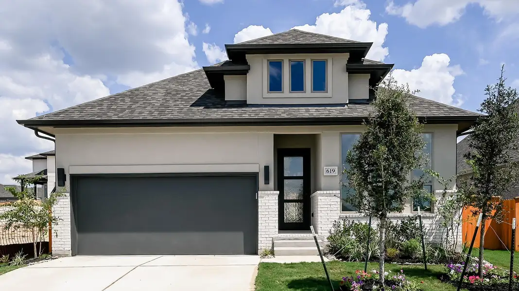 Prairie-style house featuring roof with shingles, stucco siding, brick siding, concrete driveway, and an attached garage Prairie-style house featuring roof with shingles, stucco siding, brick siding, concrete driveway, and an attached garage