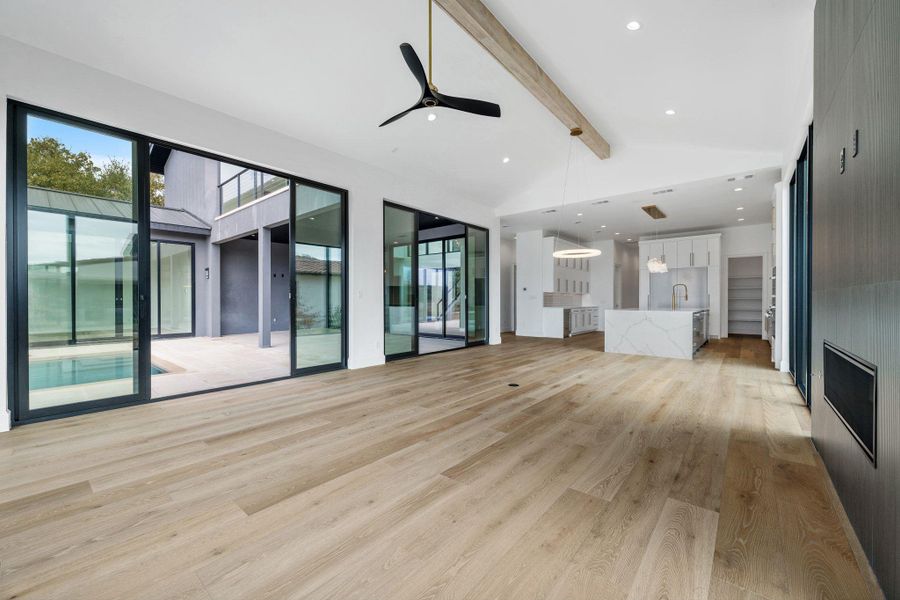 Unfurnished living room featuring light wood-type flooring, plenty of natural light, ceiling fan, and recessed lighting