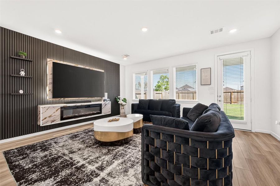 Spacious open-concept living and dining area designed for both everyday comfort and entertaining. Featuring luxury vinyl plank flooring, recessed lighting, and seamless flow into the kitchen, this inviting space offers a modern aesthetic with versatile layout options