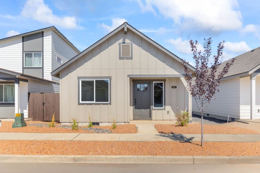 Front exterior of a new home in Feather Ridge, Redmond, OR, highlighting curb appeal (Image 2). Front exterior of a new home in Feather Ridge, Redmond, OR, highlighting curb appeal (Image 2).