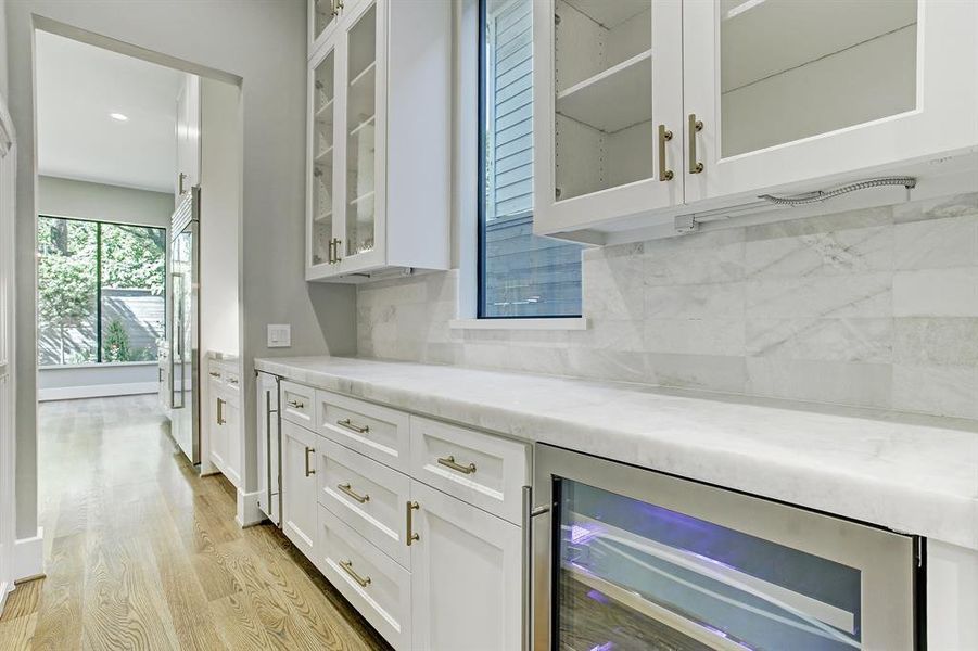 Wonderful butler's pantry with designer counters and backsplash, an abundance of shelving, cabinets and a wine cooler.  Not pictured is a large walk-in pantry.