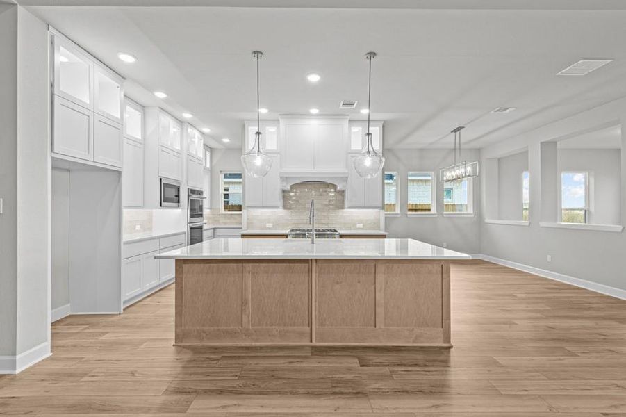 REPRESENTATIVE PHOTO: Large Kitchen and spacious dining that is encompassed by windows and light!