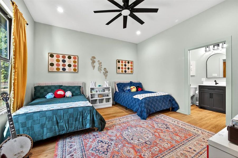 Bedroom featuring light wood-style floors, ceiling fan, recessed lighting, and ensuite bathroom Bedroom featuring light wood-style floors, ceiling fan, recessed lighting, and ensuite bathroom