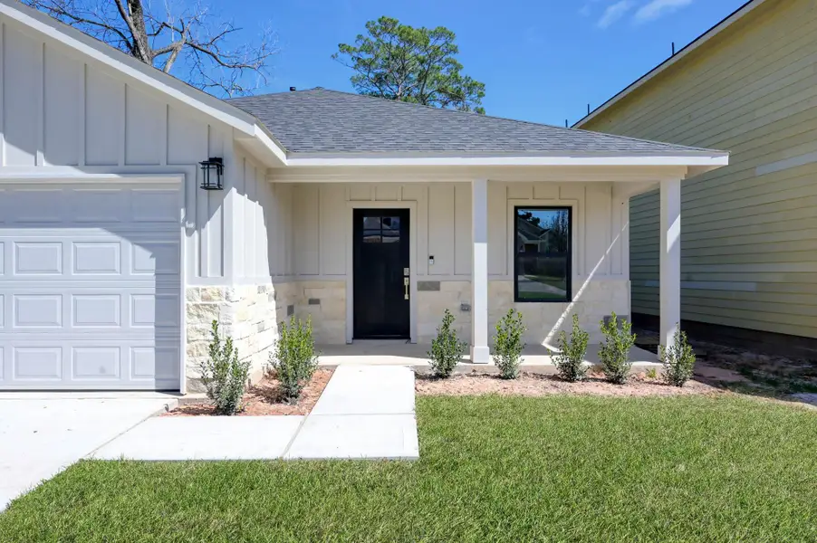 A welcoming front porch with recessed lighting and a modern glass-panel door—the perfect spot for your morning coffee.