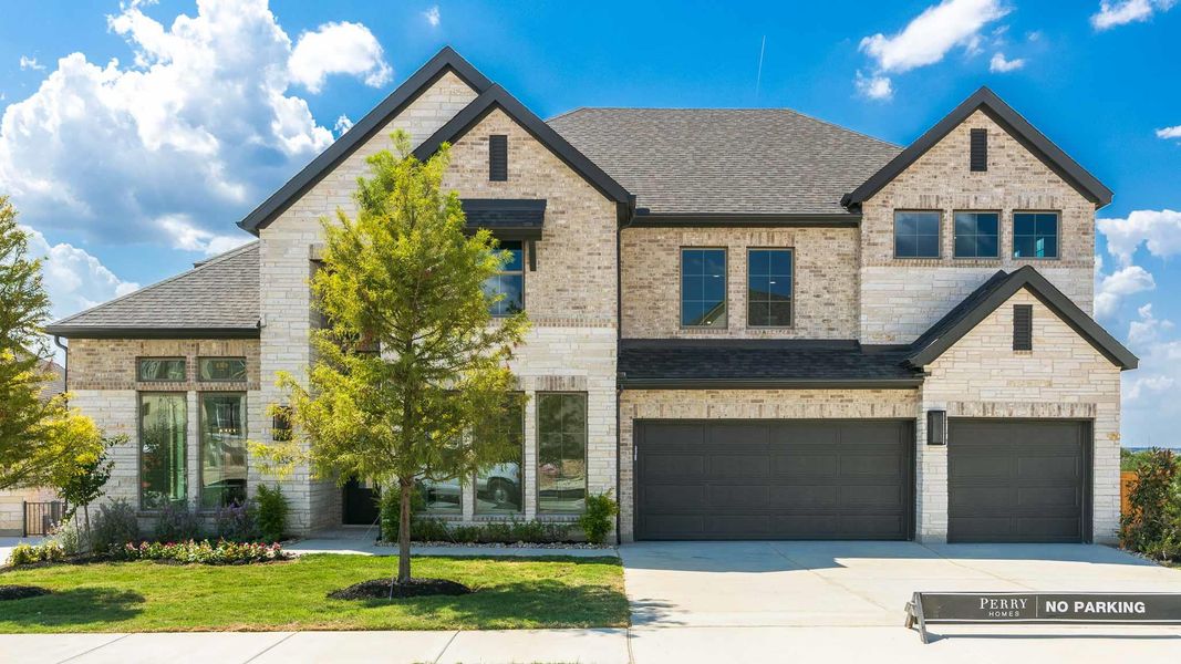 French country inspired facade with an attached garage, a shingled roof, driveway, and brick siding French country inspired facade with an attached garage, a shingled roof, driveway, and brick siding